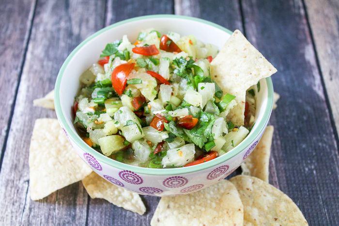 pineapple salsa up close shot with a chip in the bowl