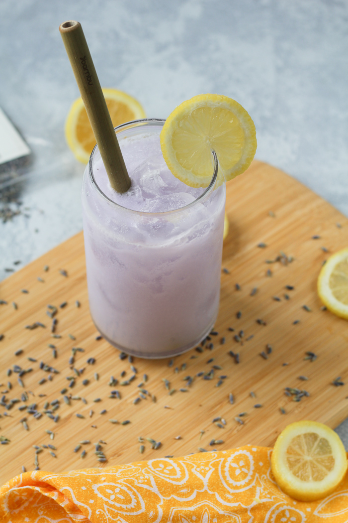 drink with lemons and lavender on a bamboo cutting board