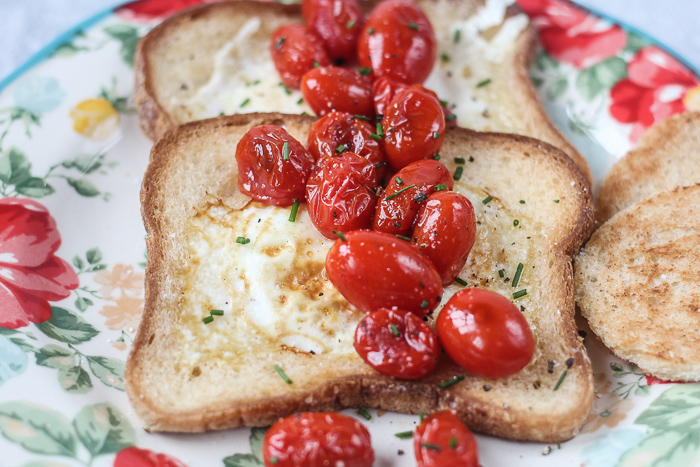 egg in the hole with bursted tomatoes featured
