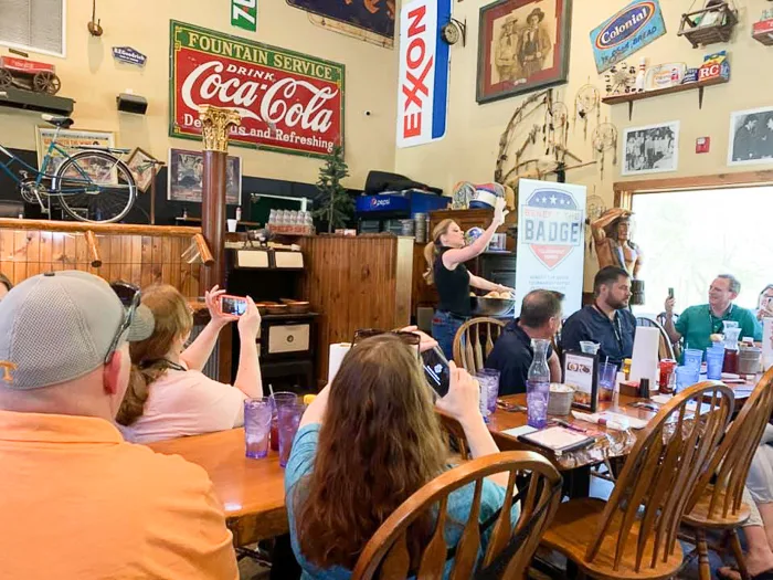 server singing and tossing rolls at fall creek