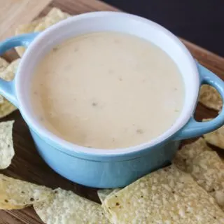 white cheese in blue bowl with tortilla chips wide shot