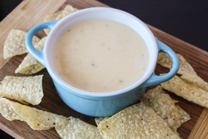 white cheese in blue bowl with tortilla chips wide shot