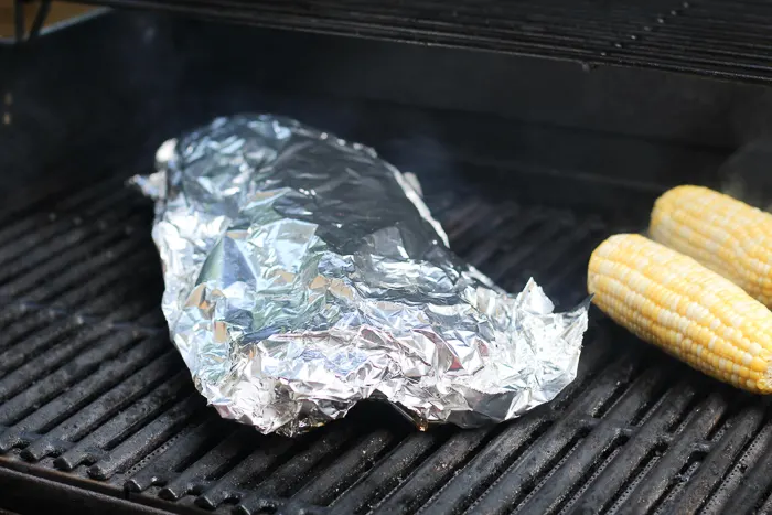 ribs on grill wrapped in aluminum foil