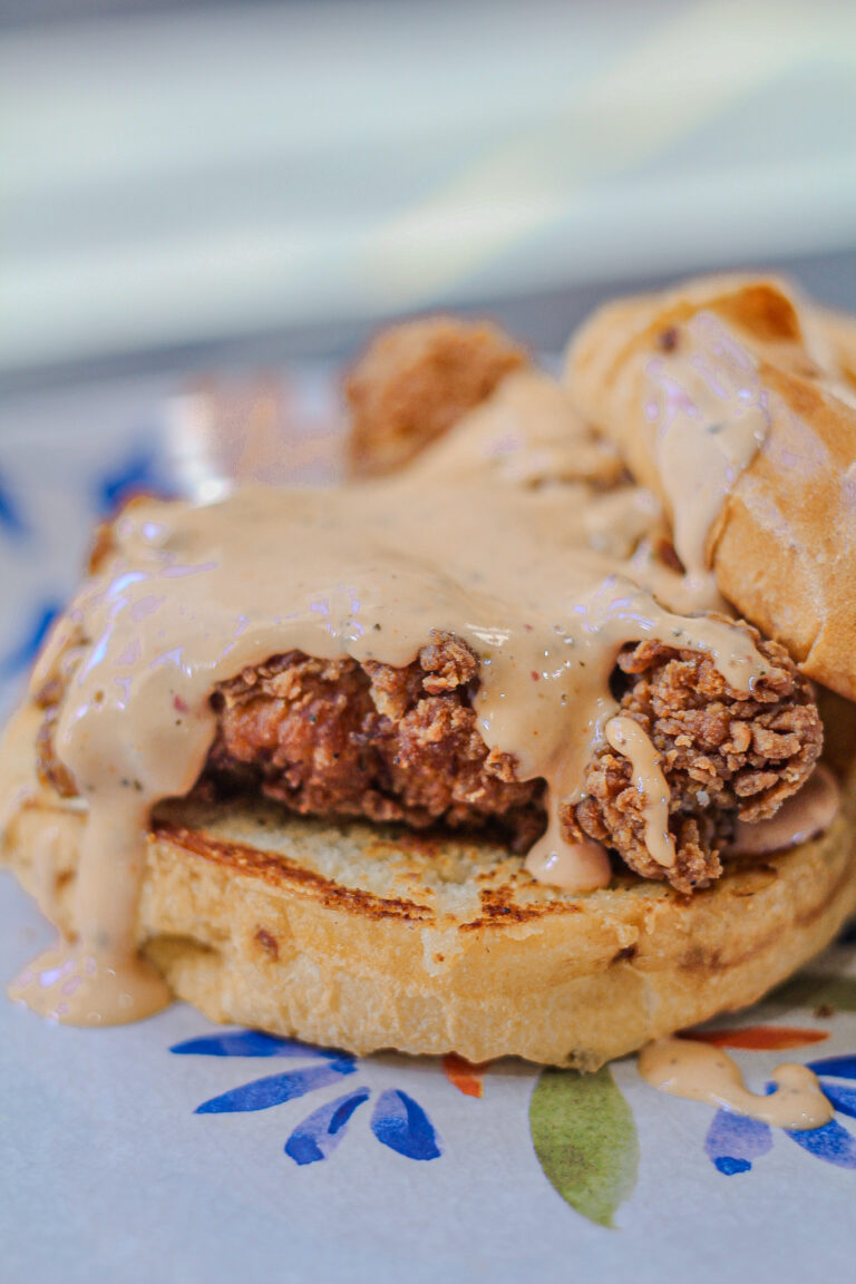 raising cane chicken sandwich covered in cane sauce